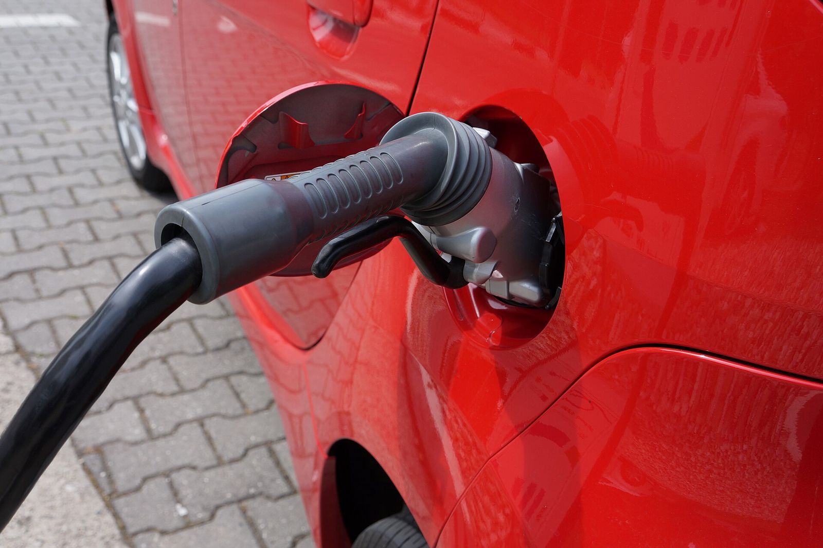 Charging cable being plugged into an electric car
